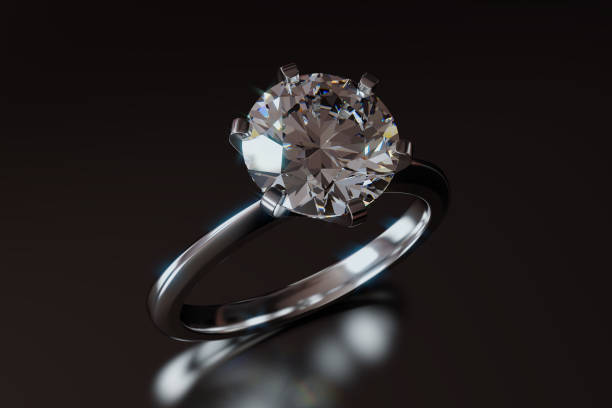 istock Close-up solitaire diamond engagement ring on dark gray glossy background 1127157255