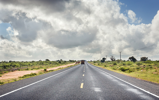 African highway from Mombasa to Nairobi in Kenya, straight asphalt road and surrounding plains