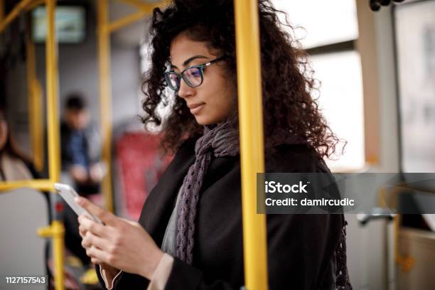 Young Woman Traveling By Bus And Using Smart Phone Stock Photo - Download Image Now - Bus, Telephone, Women