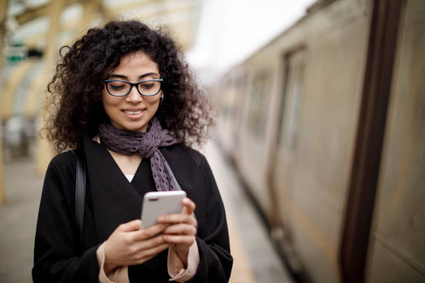 istock Young successful businesswoman using mobile phone at the subway station 1127157597