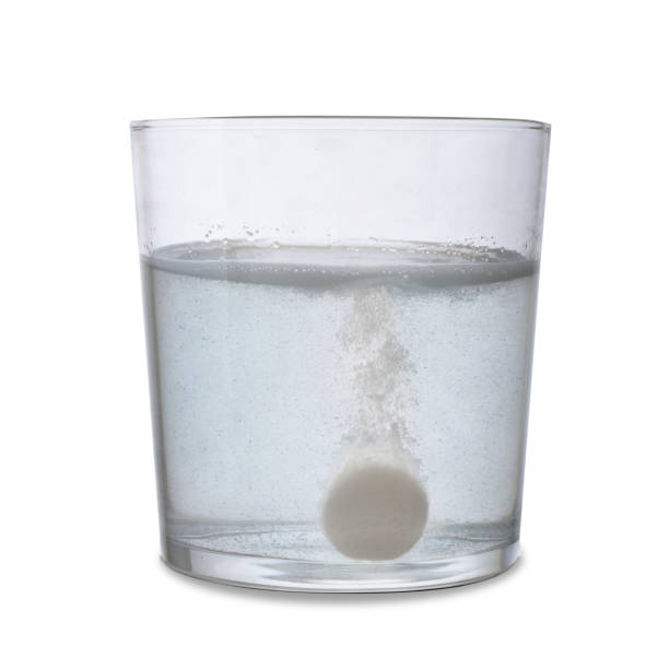 istock Effervescent tablet dissolving in a glass with water. Isolated on white background. 1127158600