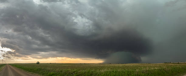 istock Panoramic view of supercell thunderstorm over the high plains in Oklahoma with a dramatic green sky. 1127158975
