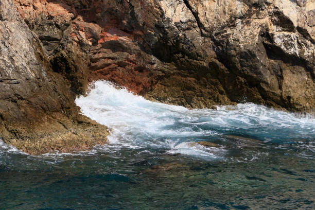 istock Rocky sea coast with the wave. 1127159250