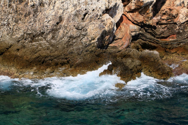 istock Rocky sea coast with the wave. 1127159260