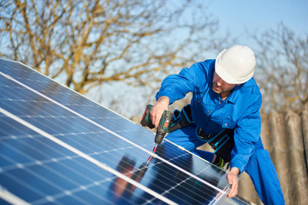 istock Electrician mounting solar panel on roof of modern house 1127159358