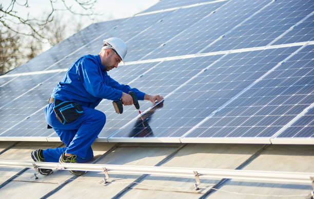 istock Electrician mounting solar panel on roof of modern house 1127159362