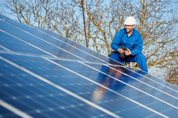 istock Electrician mounting solar panel on roof of modern house 1127159364