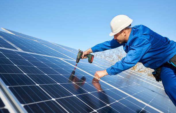 istock Electrician mounting solar panel on roof of modern house 1127159368