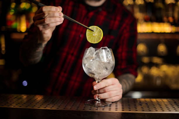 istock Barman decorating fresh sour cocktail with a slice of lime 1127159491