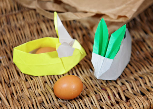 istock Handicraft origami rabbits from paper. Easter bunnies. Creative package for gift 1127160616