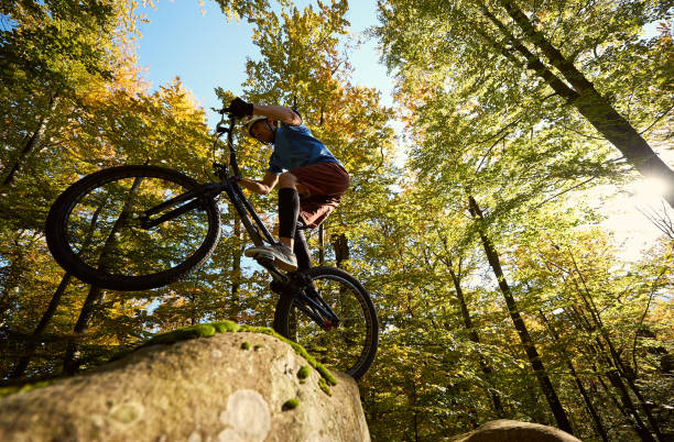 istock Sportsman cyclist balancing on back wheel on trial bicycle 1127160671
