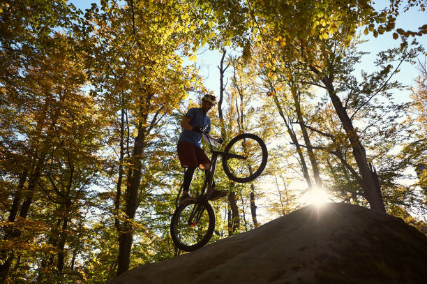 istock Sportsman cyclist balancing on back wheel on trial bicycle 1127160681