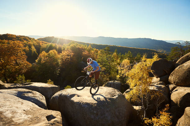 istock Sportsman cyclist balancing on back wheel on trial bicycle 1127160696