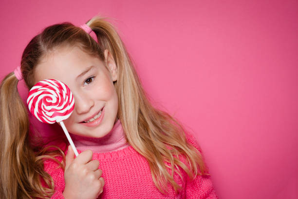 istock Young girl with lollipop 1127162299