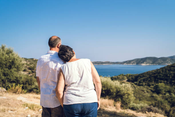 istock Senior couple at seaside viewpoint 1127162392