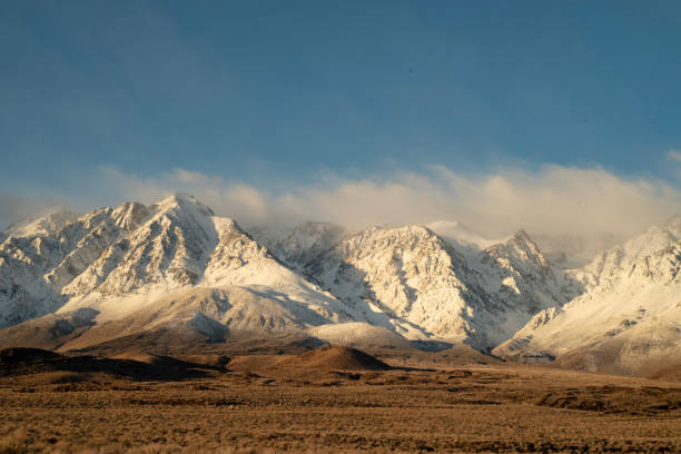 istock morning clouds around snowy mountain peaks Sierra Nevada landscape 1127163266