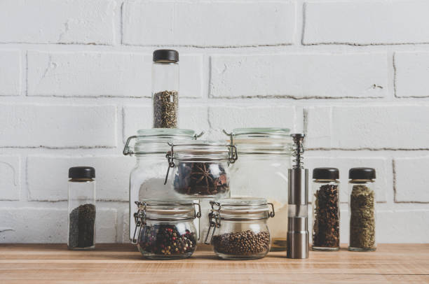 istock Colorful spices in jars on a brick wall background 1127164246