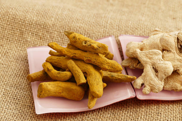 istock dry ginger and turmeric pieces on white dish, 1127164475