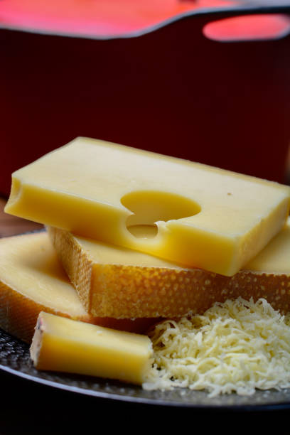 assortment of swiss cheeses emmental or emmentaler medium-hard cheese with round holes, gruyere, appenzeller and raclette used for traditional cheese fondue and gratin - cheese emmental cheese switzerland grated imagens e fotografias de stock