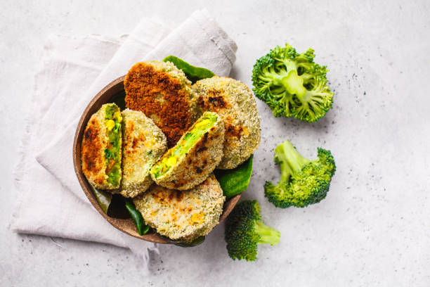 Green broccoli burgers in coconut shell dish on white background, top view. Green Veggie Cutlets in coconut shell dish on white background. Healthy vegn food concept. veggie burger stock pictures, royalty-free photos & images