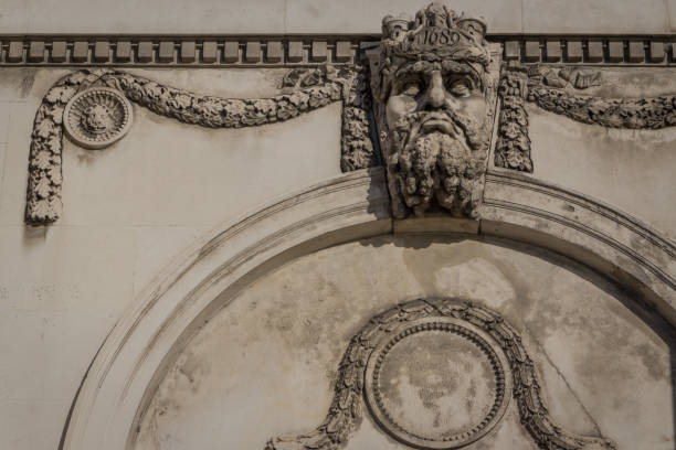 istock Decorative figure head above a window on the facade of a neoclassical building 1127166749