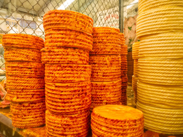 Stacks of cheese wheels truckles of Queso de Cincho (Queso Guerrero) Cincho Cheese in market. Iguala, Guerrero. stock photo