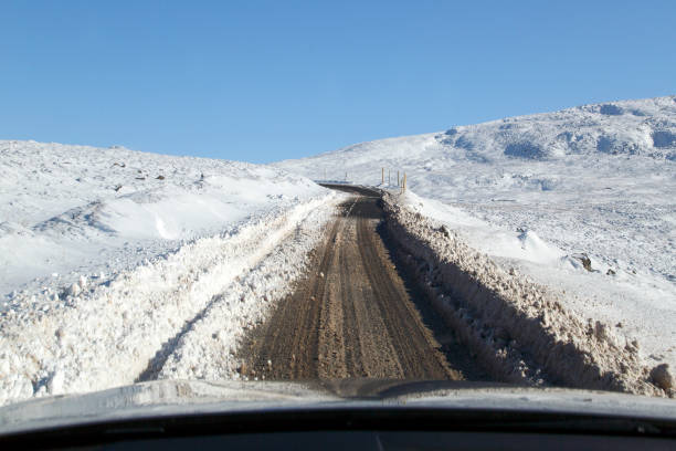 istock Driving Conditions on a Mountain Road with Winter Snow 1127169687