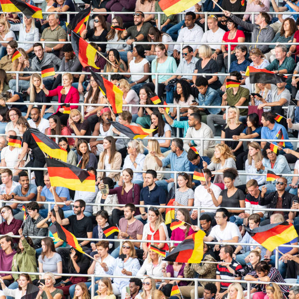 istock German fens waving flags on a stadium 1127170396