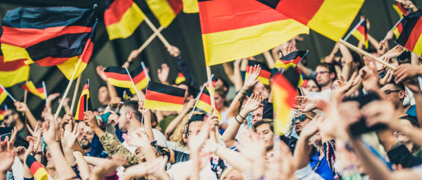 istock Germany supporters waving their flags on a stadium 1127170402