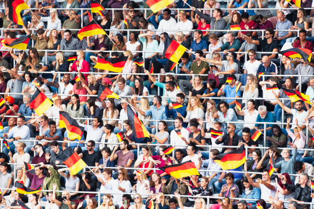 istock German fens waving flags on a stadium 1127170424