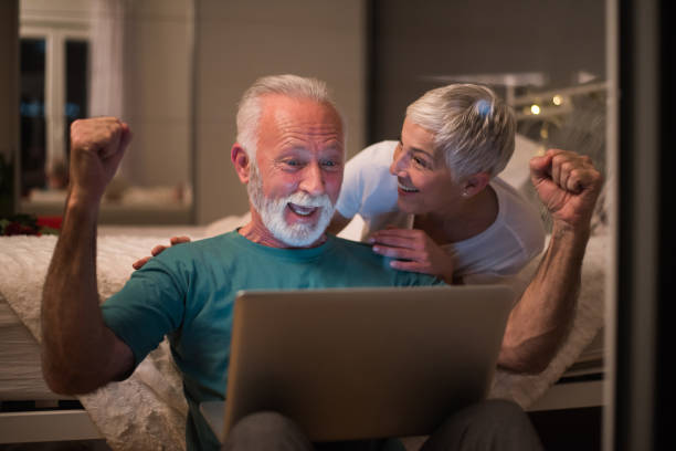 istock Happy mature couple using laptop 1127170790