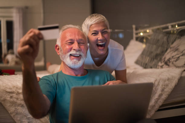 istock Couple shopping online and smiling 1127170824