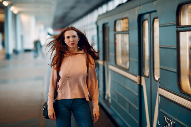 istock Positive redhead young female in subway portrait 1127170835