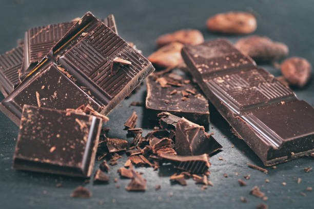 istock Broken dark chocolate, cocoa powder and coffee beans 1127172390