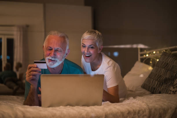istock Smiling couple shopping online 1127173287