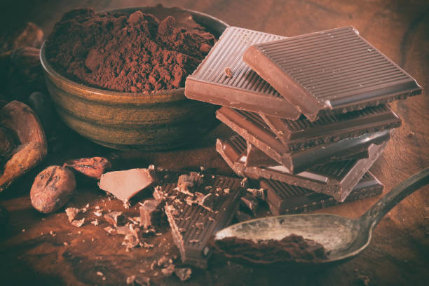 istock Broken dark chocolate, cocoa powder and coffee beans on a wooden table 1127173920