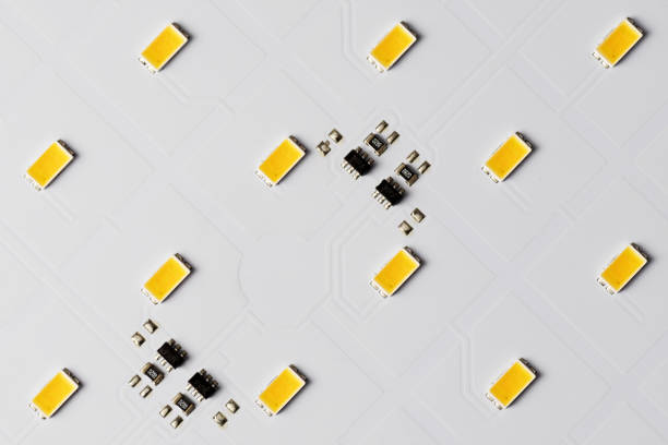 Top view of white aluminum printed circuit board with SMD LEDs and microchips stock photo