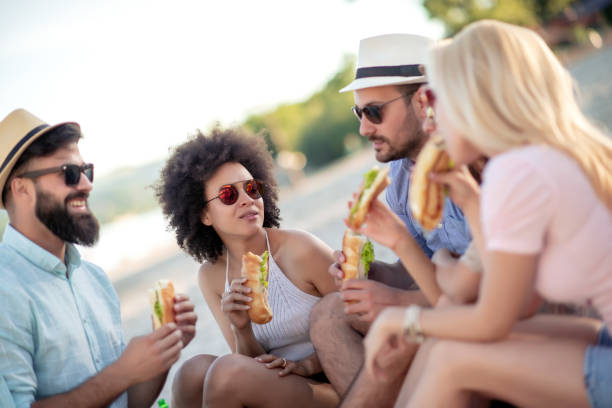 istock Group of young people eating sandwiches 1127177700