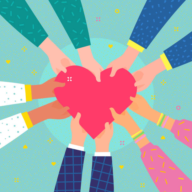 istock Concept of charity and donation. Several people hold the heart 1127178016