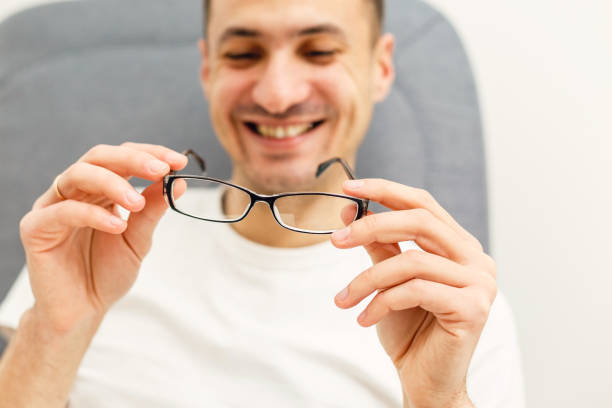 istock Young man puts his glasses on 1127181184