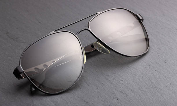 istock Black polarizing sunglasses in a metal frame on a black fabric background 1127181384