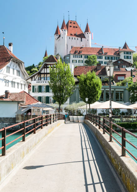 Footbridge over the Aare in Thun, Switzerland Footbridge over the river with Schloss Thun in Background lake thun stock pictures, royalty-free photos & images