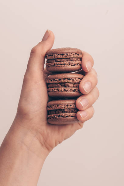 istock The female hand holding macaroons 1127186406