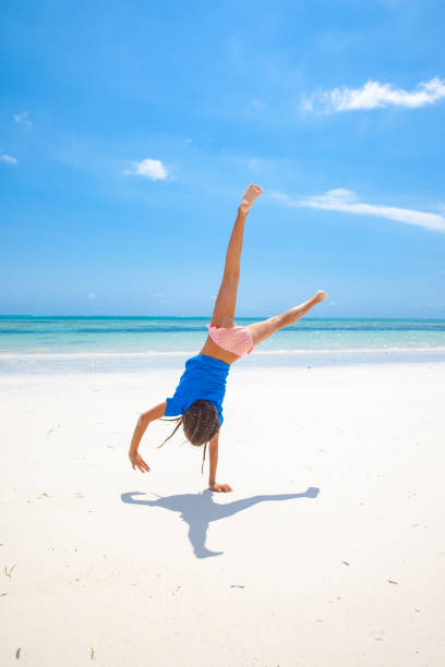 istock Playful Little girl on Idyllic white sandy beach 1127187142