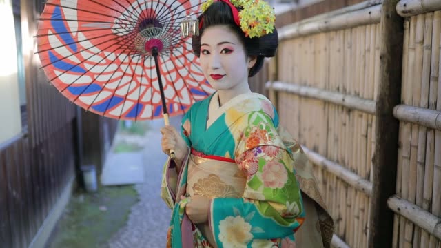 Maiko Apprentice Geisha standing on narrow street in Gion, Kyoto