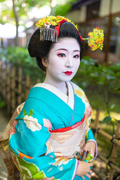 istock Maiko Apprentice Geisha standing on narrow path in Gion, Kyoto 1127190945