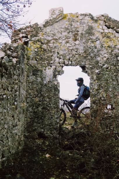 istock Old abandoned church and mountain biker 1127190954