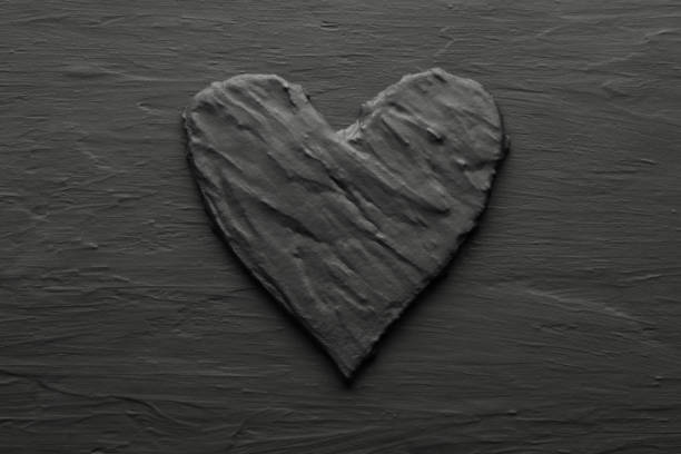 Dark black heart on rough slate like background