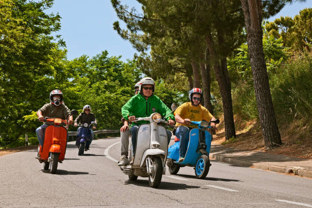 bikers riding vintage italian scooters vespa and lambretta - vespa scooter imagens e fotografias de stock