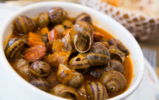 istock Home style snails stewed with chorizo 1127193657